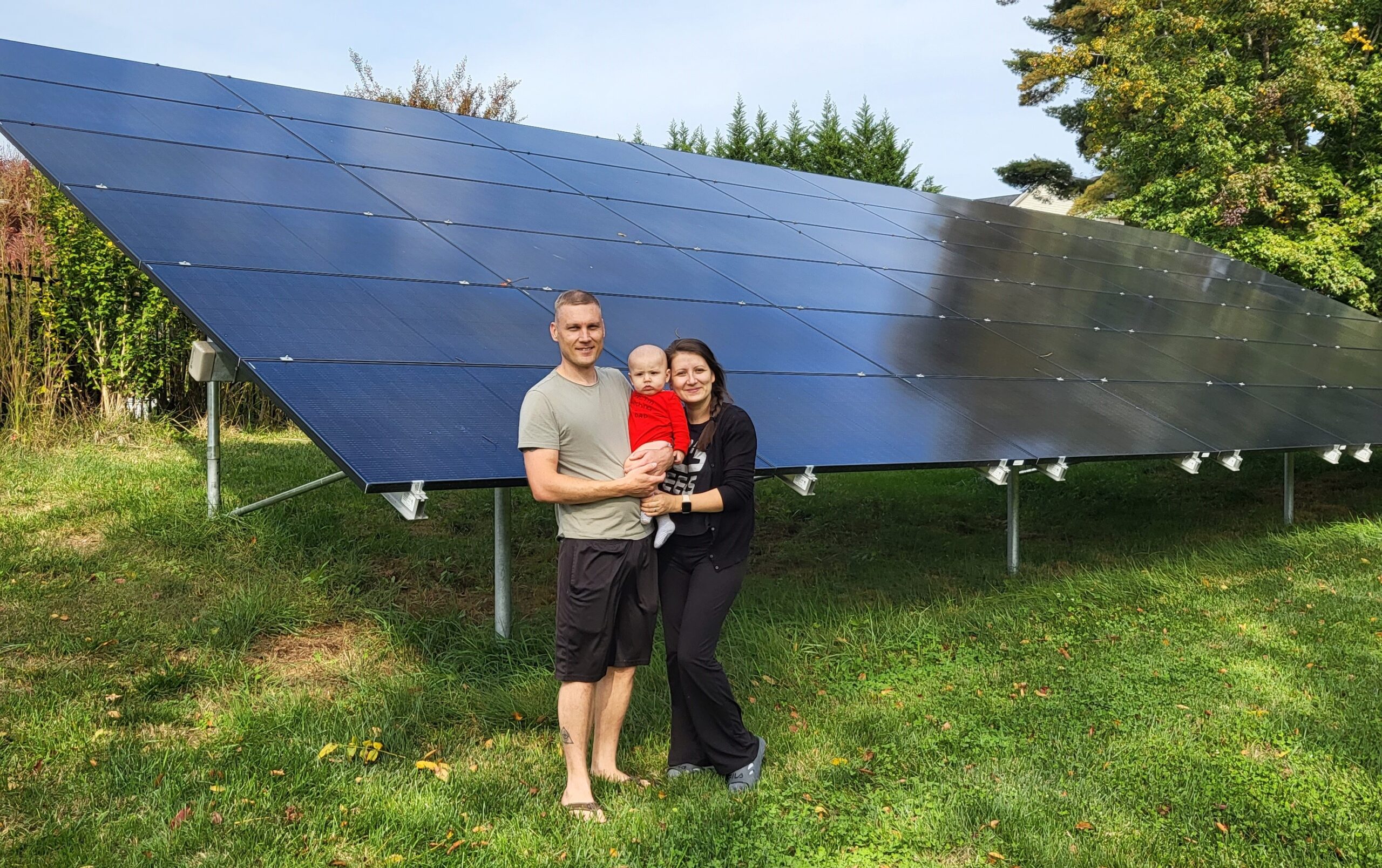 family in front of their new home solar panels