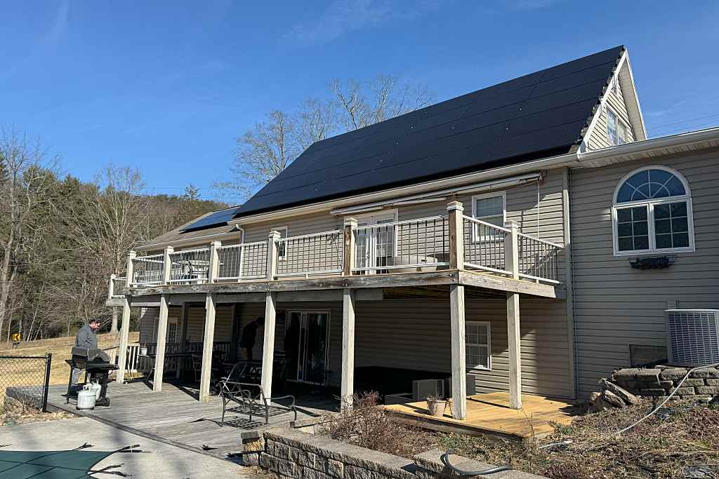 two story home with residential solar panels installed