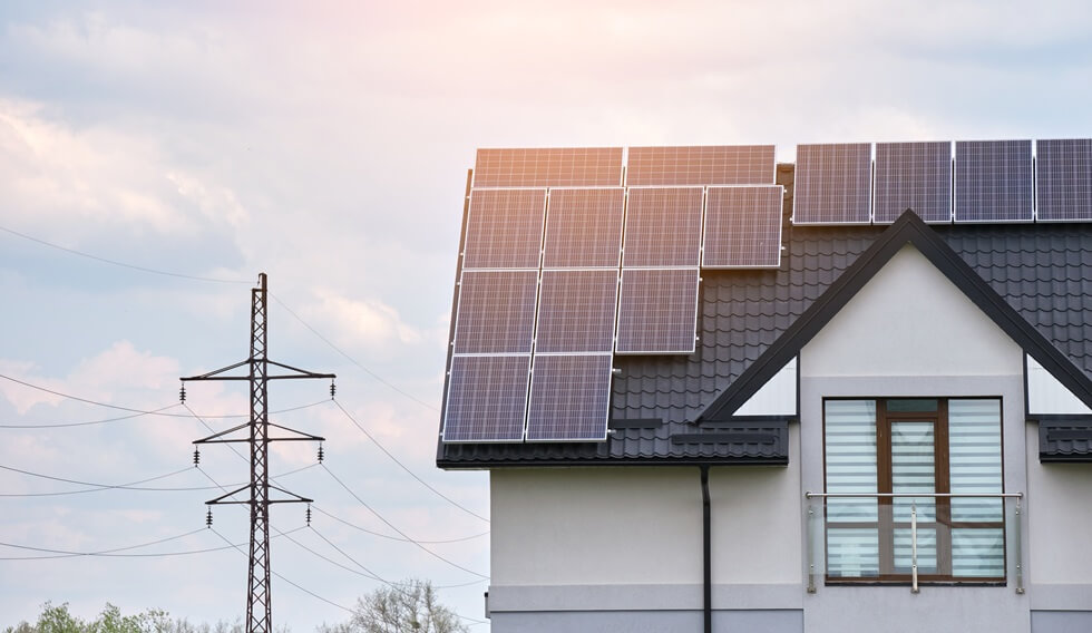 MD residential house with rooftop covered with solar photovoltaic panels for producing of clean ecological electrical energy in suburban rural area