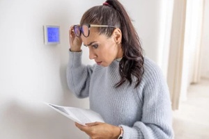 women shocked after reading an energy bill