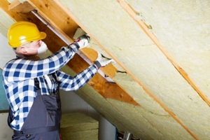 worker installing home insulation panels