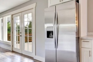 bright kitchen room with steel appliances and granite tops