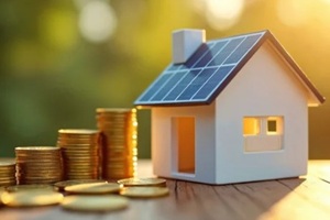 model house with solar panels sits beside stacks of gold coins