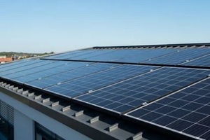 solar panels installed on a building roof in bright daylight