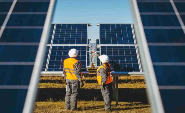 Employees Working in Solar Power Station