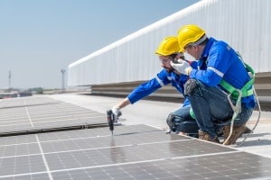 Workers Installing Solar Panels on Commercial Property Rooftop in Maryland