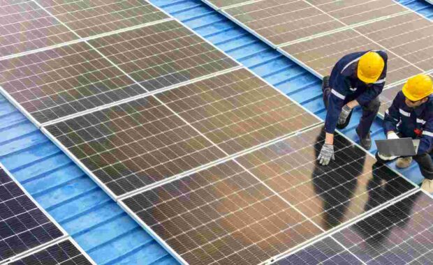 Professional Inspecting Solar Panel Installations on A Rooftop