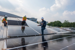 Engineer Checking Installation of Solar Cell on Roof of Factory