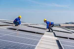 Solar Panel Technicians Installing Solar Panels on A Commercial Building