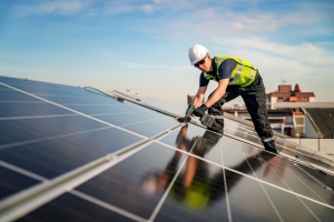 Worker Installing Solar Panels on A Maryland Home Rooftop