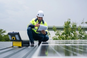 Engineer Inspecting Solar Panels on Home Rooftop in Maryland