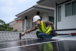 Engineer Installing Solar Panels on Residential Building