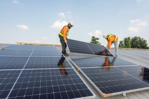 Technicians Installing Solar Panels on a House Rooftop in Maryland