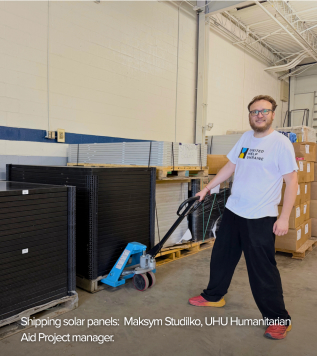 Maksym Studilko, UHU Humanitarian Aid Project manager, moving donated solar panels at the Gaithersburg, Maryland warehouse.