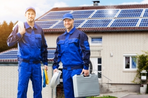 Smiling Solar Technicians Outside a Home for Regular Maintenance