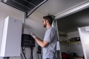 Technician Installing a Solar Battery Storage System in a Maryland Home